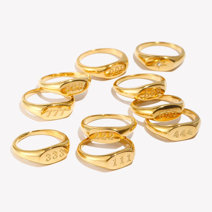 Gold rings with engraved numbers on a white background