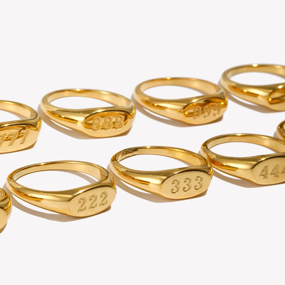 Angel Number Gold rings with numbers engraved on a white background